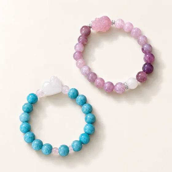 Two strands: amazonite with rose quartz and a clear quartz cat, and Madagascar rose quartz with white moonstone.